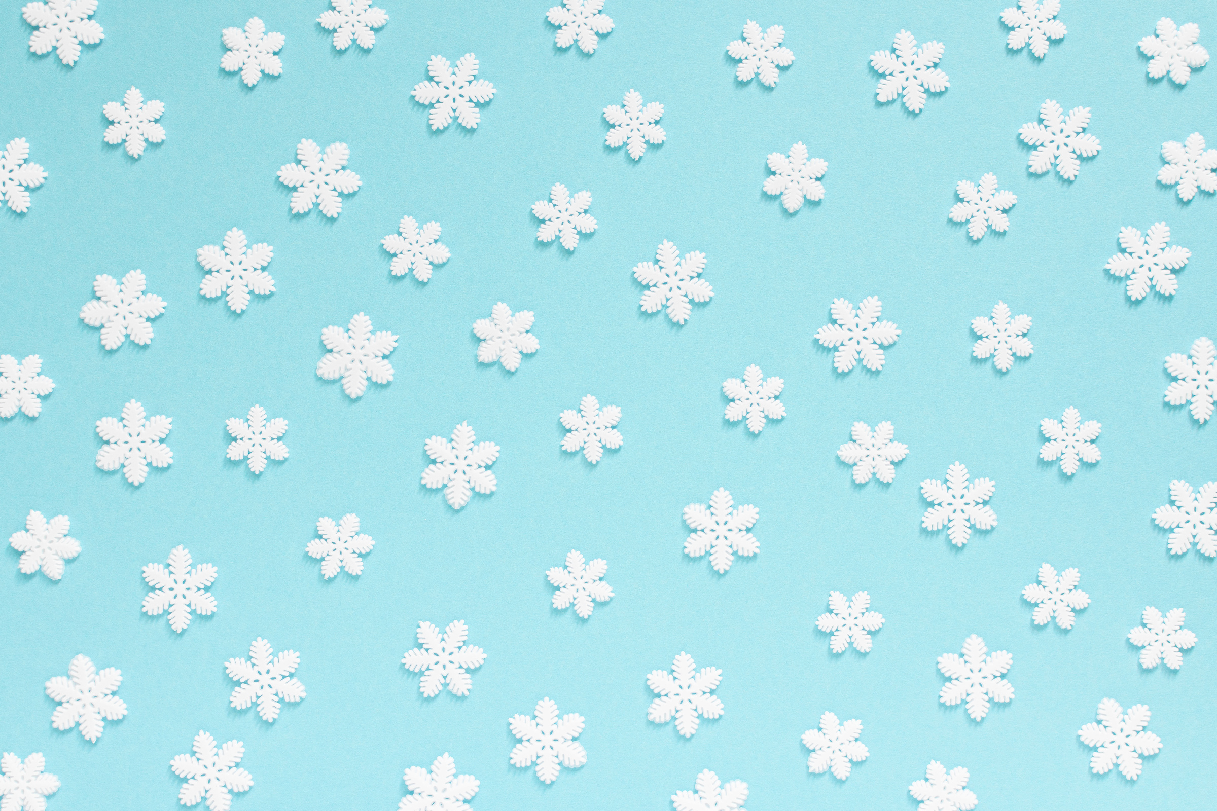 Holiday blue background with white snowflakes